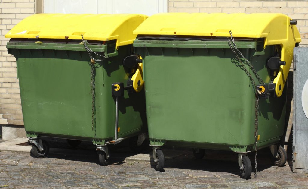 two yellow and green dumpster